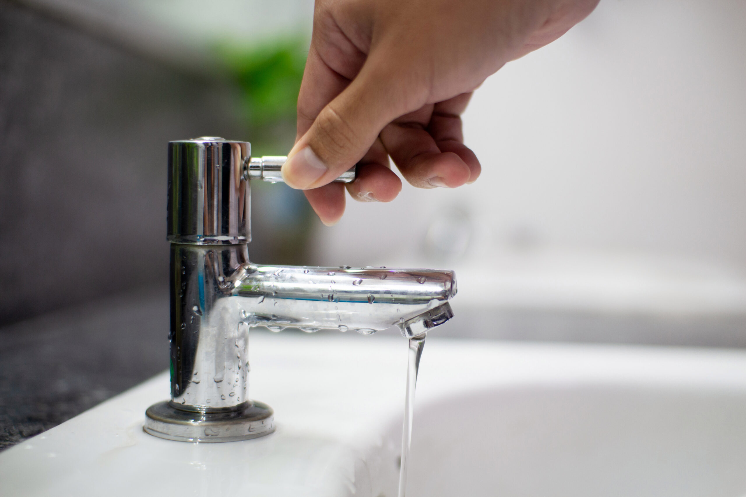 Man turning off the tap